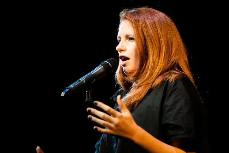 Beryl Kahn talking into a microphone