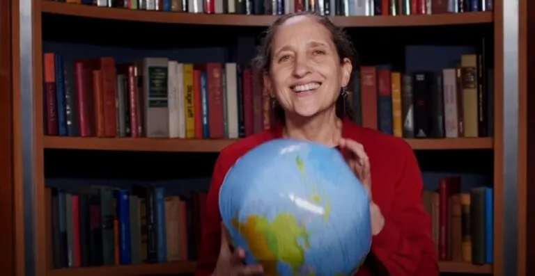 Ruth DeFries holding inflatable globe.