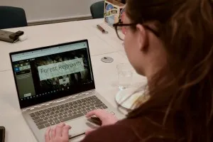 A woman sitting looking at a computer screen