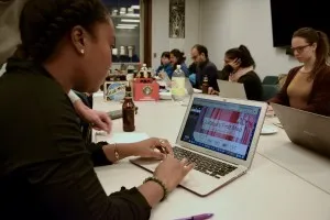 Woman sitting looking at a laptop screen